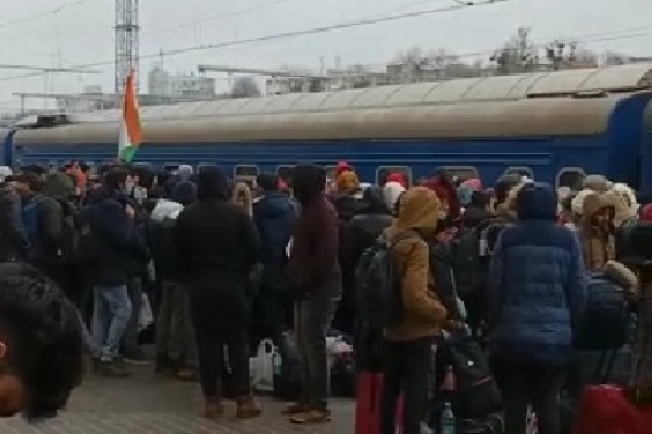 Students queue up at Kharkiv railway station as doors of trains remain shut