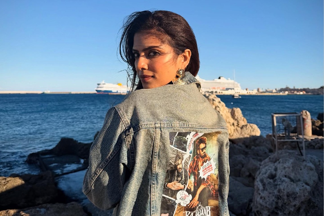 After director Maruthi, actress Malavika Mohanan now sports outfit bearing 'The Raja Saab' poster in Greece