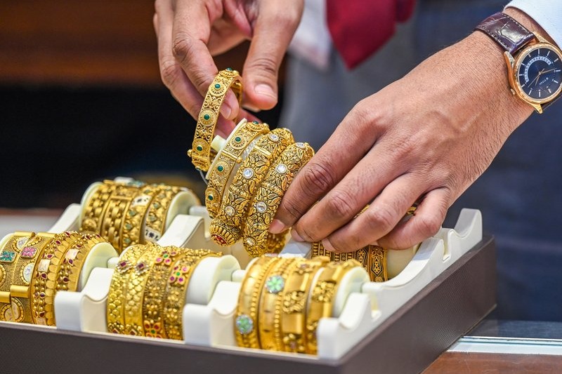 Gold edges up, silver slips after record high
