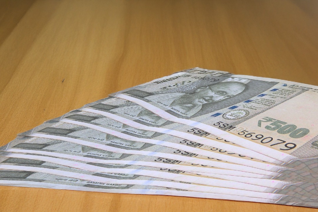 Rupee slides over weak global cues, FII outflows