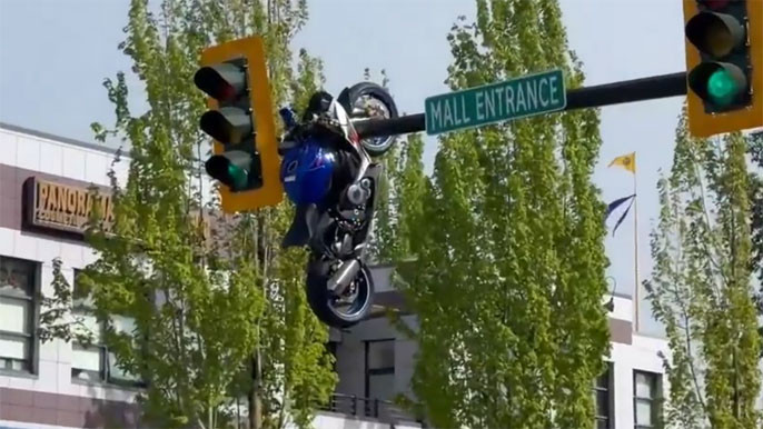 British Columbia Accident Bike crashes into car hangs on traffic light