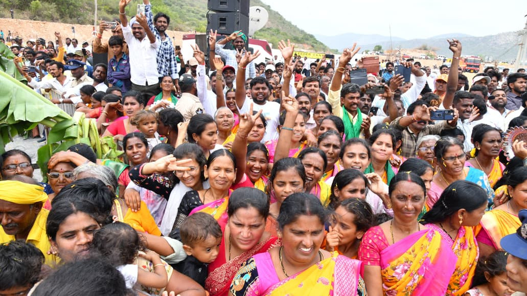 People sprinkle Krishna water on heads and carry bottles at Veligonda Project