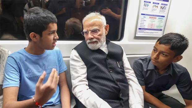 Narendra Modi surprises passengers in Delhi Metro and interacts with children