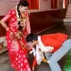 Groom takes blessings from wife
