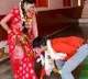 Groom takes blessings from wife
