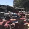 People sell household items alongside Kabul streets