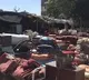 People sell household items alongside Kabul streets