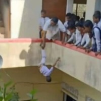 Principal hangs kid upside down from building