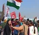 Farmers celebrate as they leave their protest site Kaushambi