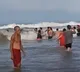 This is the breathtaking moment when beachgoers formed a human chain