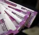 People rush to collect toy currency notes on Madapur raod