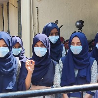More Karnataka students wear saffron shawls, hijabs