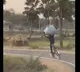 Youth carries grass on his head races on cycle