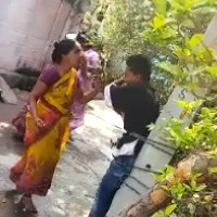 Watch: Woman bashes up her drug addict son after tying to a pole