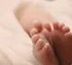 infant in pastic cover
