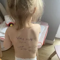 Ukraine Mothers writing family details on their children back