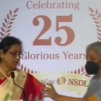 Nirmala Sitharaman gives drinking water to NSDL MD Padmaja Chunduru on stage