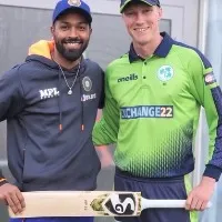 Hardika Panda presents his bat to Irish young cricketer Harry Tector