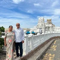 tdp mla gorantla posts a photo with his wife at new jersey venkateswara swamy temple