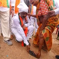 bjp posts a photo of bandi sanjay arranges slippers to a older lady