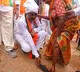 bjp posts a photo of bandi sanjay arranges slippers to a older lady