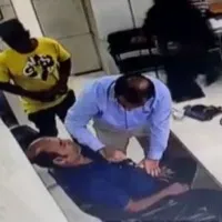Doctor performs CPR on patient as he suffers heart attack in the clinic