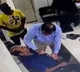 Doctor performs CPR on patient as he suffers heart attack in the clinic