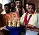 A devotee donates three golden crowns to goddess Kanaka Durga