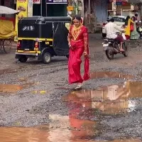 Kerala bride walks on road full of potholes
