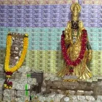 Gold and currency decorated deity in Penugonda