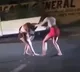 Two women fight violently on a busy street
