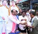 a trs leader distributes a hen and a quarter liquor bottle to poor in warangal