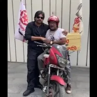 Pawan Kalyan presents a mobile phone to party worker Balaji