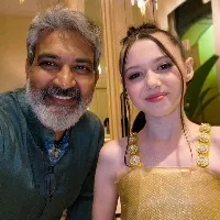 Rajamouli takes award from child actress Violet Mcgraw for RRR