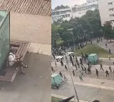 Man keeps eating his sandwich as rioters police clash in France