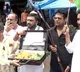 Cong workers buy tomatoes carrying briefcase and gun to protest against price rise