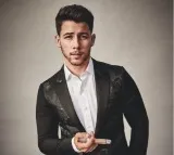 Nick Jonas falls through hole on stage while performing