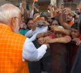 Woman ties rakhi to PM Modi as huge crowd gathers outside polling booth in Ahmedabad