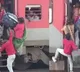 couple boards running train with luggage and travel on footboard