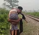 Shattered Brother Carries Sisters Body On Shoulders After She Dies Due To Typhoid As No Medical Help Could Reach Her Due To Floods