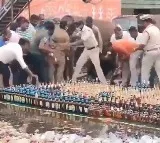 Andhra cops line up liquor bottles for disposal locals grab and run off