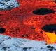 fire vs ice lava oozing over snow in Iceland