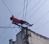 Drunk man climbs electric pole, lies down on wires in Andhra Pradesh