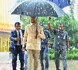 CM Chandrababu Carries His Own Umbrella in Rain