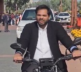 Gaddam Vamsi Rides Electric Bike to Parliament Over Delhi Pollution