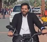 Gaddam Vamsi Rides Electric Bike to Parliament Over Delhi Pollution