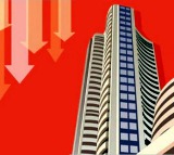 Sensex, Nifty end lower after volatile session