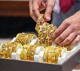 Gold dips marginally, silver drops near 2 pc as US dollar gains