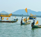 Fishermen Wish Telugu Desam Party With Yellow Festoons in Krishna River