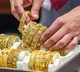 Gold gains for third consecutive week amid dollar weakness